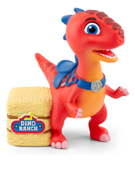 a small orange t-rex with a blue saddle next to a bale of straw
