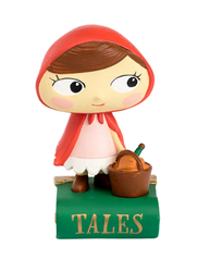 a figurine girl with a red cloak and a basket standing ontop of a book