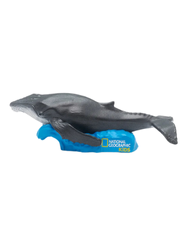 a figurine of a humpback whale on a blue wave